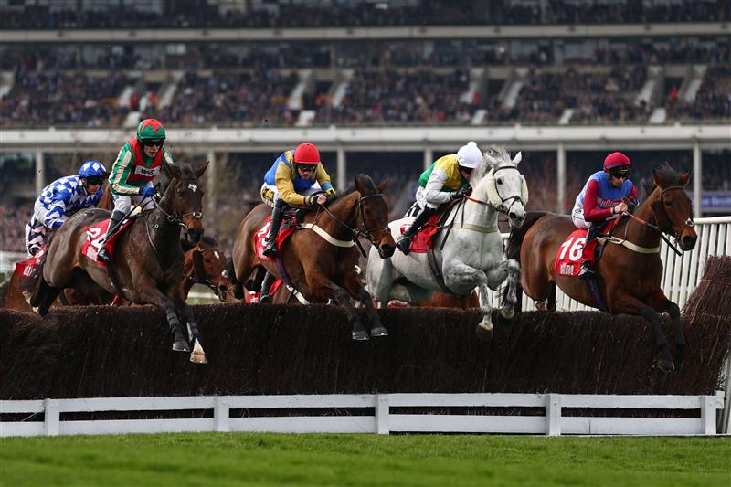 The field take the water-jump in the Ultima Handicap Chase on the first day of the Cheltenham Festival at Cheltenham Racecourse, in Cheltenham, England on March 15, 2022. (Photo by Adrian DENNIS / AFP) (Photo by ADRIAN DENNIS/AFP via Getty Images)