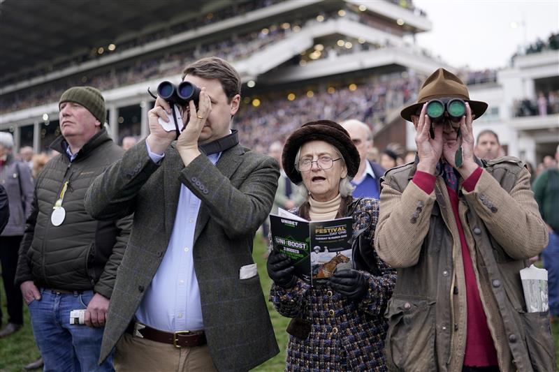 CHELTENHAM, ENGLAND - MARCH 15: Racegoers watch the action from the lawns on day one of The Festival at Cheltenham Racecourse on March 15, 2022 in Cheltenham, England. (Photo by Alan Crowhurst/Getty Images)
