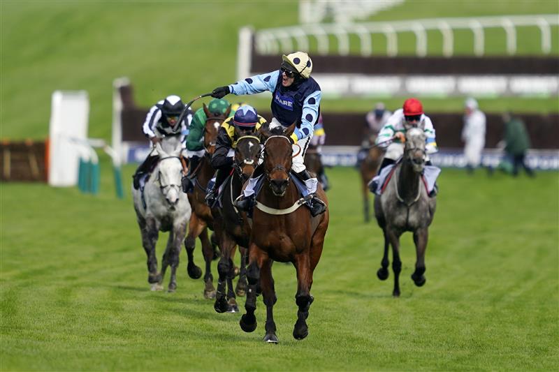 CHELTENHAM, ENGLAND - MARCH 15: Tom Cannon on Edwardstone (yellow cap, blue dots) reacts as they approach the finish line to win Arkle Chase race during day one of the Cheltenham Festival 2022 at Cheltenham Racecourse on March 15, 2022 in Cheltenham, England. (Photo by Alan Crowhurst/Getty Images)