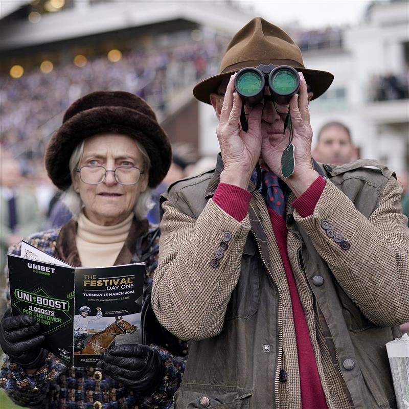 CHELTENHAM, ENGLAND - MARCH 15: Racegoers watch the action from the lawns on day one of The Festival at Cheltenham Racecourse on March 15, 2022 in Cheltenham, England. (Photo by Alan Crowhurst/Getty Images)