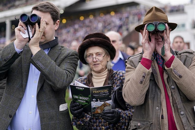 CHELTENHAM, ENGLAND - MARCH 15: Racegoers watch the action from the lawns on day one of The Festival at Cheltenham Racecourse on March 15, 2022 in Cheltenham, England. (Photo by Alan Crowhurst/Getty Images)