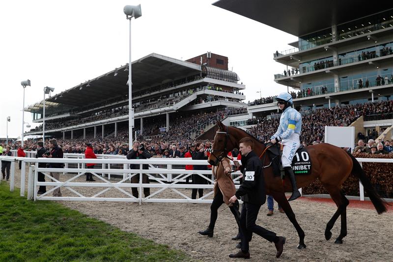 Jockey Rachael Blackmore on hot favourite, Honeysuckle, walk out onto the course ahead of the Champion Hurdle on the first day of the Cheltenham Festival at Cheltenham Racecourse, in Cheltenham, England on March 15, 2022. (Photo by Adrian DENNIS / AFP) (Photo by ADRIAN DENNIS/AFP via Getty Images)