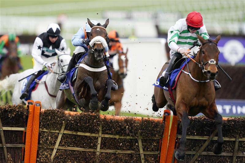 CHELTENHAM, ENGLAND - MARCH 15: Nico de Boinville on Marie's Rock (light blue kit) jumps the last hurdle to win The Mares’ Hurdle race before Jack Kennedy on Queens Brook (red cap) during day one of the Cheltenham Festival 2022 at Cheltenham Racecourse on March 15, 2022 in Cheltenham, England. (Photo by Alan Crowhurst/Getty Images)