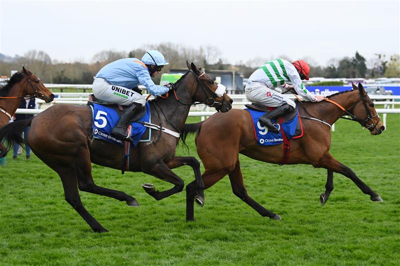 CHELTENHAM, ENGLAND - MARCH 15: Nico de Boinville on Marie's Rock (light blue kit) approach the finish line to win The Mares’ Hurdle race before Jack Kennedy on Queens Brook (red cap) during day one of the Cheltenham Festival 2022 at Cheltenham Racecourse on March 15, 2022 in Cheltenham, England. (Photo by Mike Hewitt/Getty Images)