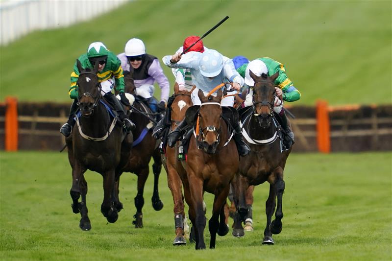 CHELTENHAM, ENGLAND - MARCH 15: Rachel Blackmore on Honeysuckle (blue and white cap) approach the finish line before Aidan Coleman on Epatante (white cap) and Jack Kennedy on Zanahiyr (red cap) to win The Unibet Champion Hurdle race during day one of the Cheltenham Festival 2022 at Cheltenham Racecourse on March 15, 2022 in Cheltenham, England. (Photo by Alan Crowhurst/Getty Images)