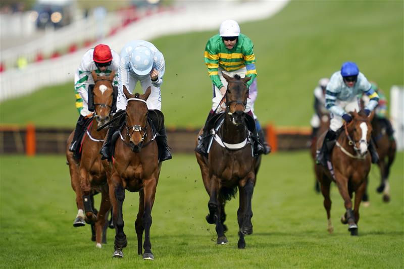 CHELTENHAM, ENGLAND - MARCH 15: Rachel Blackmore on Honeysuckle (blue and white cap) approach the finish line before Aidan Coleman on Epatante (white cap) and Jack Kennedy on Zanahiyr (red cap) to win The Unibet Champion Hurdle race during day one of the Cheltenham Festival 2022 at Cheltenham Racecourse on March 15, 2022 in Cheltenham, England. (Photo by Alan Crowhurst/Getty Images)