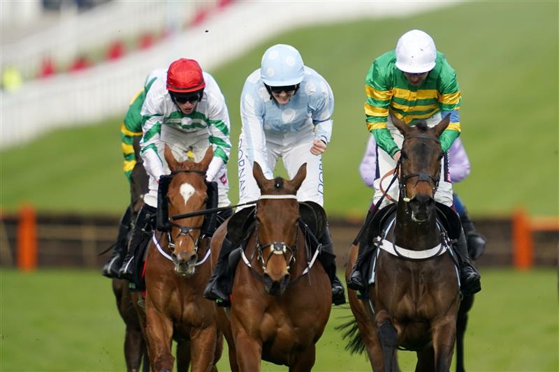 CHELTENHAM, ENGLAND - MARCH 15: Rachel Blackmore on Honeysuckle (blue and white cap) approach the finish line before Aidan Coleman on Epatante (white cap) and Jack Kennedy on Zanahiyr (red cap) to win The Unibet Champion Hurdle race during day one of the Cheltenham Festival 2022 at Cheltenham Racecourse on March 15, 2022 in Cheltenham, England. (Photo by Alan Crowhurst/Getty Images)