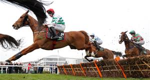 Jockey Jack Kennedy and Zanahiyr jump a hurdle during the Champion Hurdle on the first day of the Cheltenham Festival at Cheltenham Racecourse, in Cheltenham, England on March 15, 2022. (Photo by Adrian DENNIS / AFP) (Photo by ADRIAN DENNIS/AFP via Getty Images)