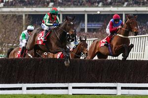 Runner-up, Jockey Tom Scudamore on Gericault Roque (L) jumps a fence in the Ultima Handicap Chase on the first day of the Cheltenham Festival at Cheltenham Racecourse, in Cheltenham, England on March 15, 2022. (Photo by Adrian DENNIS / AFP) (Photo by ADRIAN DENNIS/AFP via Getty Images)