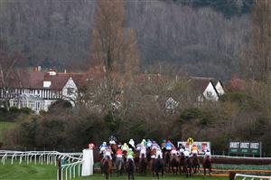 The field take a flight in the Ultima Handicap Chase on the first day of the Cheltenham Festival at Cheltenham Racecourse, in Cheltenham, England on March 15, 2022. (Photo by Adrian DENNIS / AFP) (Photo by ADRIAN DENNIS/AFP via Getty Images)