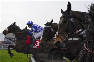 CHELTENHAM, ENGLAND - MARCH 15: A general view as runners clear the fence on the bend during The Ultima Handicap Chase on day one of The Festival at Cheltenham Racecourse on March 15, 2022 in Cheltenham, England. (Photo by Alan Crowhurst/Getty Images)