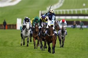 CHELTENHAM, ENGLAND - MARCH 15: Tom Cannon on Edwardstone (yellow cap, blue dots) reacts as they approach the finish line to win Arkle Chase race during day one of the Cheltenham Festival 2022 at Cheltenham Racecourse on March 15, 2022 in Cheltenham, England. (Photo by Alan Crowhurst/Getty Images)