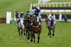 CHELTENHAM, ENGLAND - MARCH 15: Tom Cannon on Edwardstone (yellow cap, blue dots) reacts as they approach the finish line to win Arkle Chase race during day one of the Cheltenham Festival 2022 at Cheltenham Racecourse on March 15, 2022 in Cheltenham, England. (Photo by Alan Crowhurst/Getty Images)