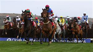 CHELTENHAM, ENGLAND - MARCH 15: Runners and riders jump the 3rd last during the Ultima Handicap Chase at Cheltenham Racecourse on March 15, 2022 in Cheltenham, England. (Photo by Mike Hewitt/Getty Images)