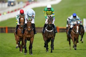 CHELTENHAM, ENGLAND - MARCH 15: Rachel Blackmore on Honeysuckle (blue and white cap) approach the finish line before Aidan Coleman on Epatante (white cap) and Jack Kennedy on Zanahiyr (red cap) to win The Unibet Champion Hurdle race during day one of the Cheltenham Festival 2022 at Cheltenham Racecourse on March 15, 2022 in Cheltenham, England. (Photo by Alan Crowhurst/Getty Images)