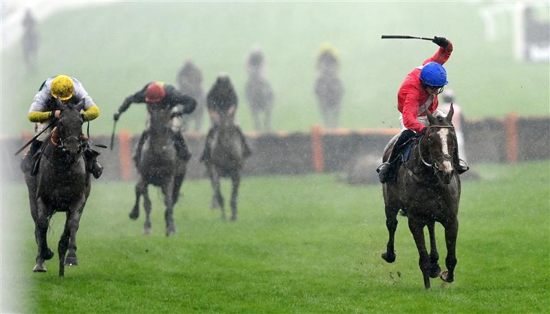 CHELTENHAM, ENGLAND - MARCH 16: Paul Townend (R, blue cap) on Sir Gerhard approach the finish line to win the Ballymore Novices' Hurdle race before Davy Russell (L, yellow cap) on Three Stripe Life during day two of Cheltenham Festival 2022 at Cheltenham Racecourse on March 16, 2022 in Cheltenham, England. (Photo by Mike Hewitt/Getty Images)