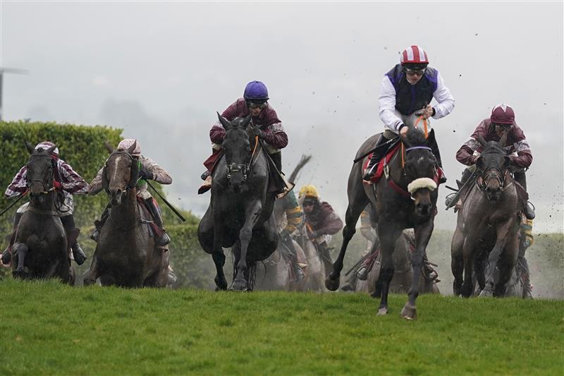 CHELTENHAM, ENGLAND - MARCH 16: Jack Kennedy riding Delta Work (L, blue cap) jump the 'Cheese Wedges' on their way to winning The Glenfarclas Chase on day two of The Festival at Cheltenham Racecourse on March 16, 2022 in Cheltenham, England. (Photo by Alan Crowhurst/Getty Images)