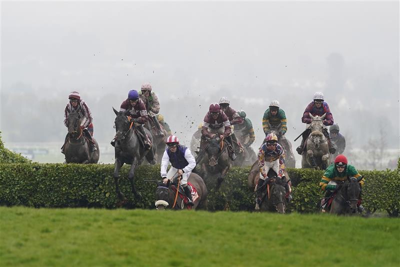 CHELTENHAM, ENGLAND - MARCH 16: Jack Kennedy riding Delta Work (L, blue cap) jump the 'Cheese Wedges' on their way to winning The Glenfarclas Chase on day two of The Festival at Cheltenham Racecourse on March 16, 2022 in Cheltenham, England. (Photo by Alan Crowhurst/Getty Images)