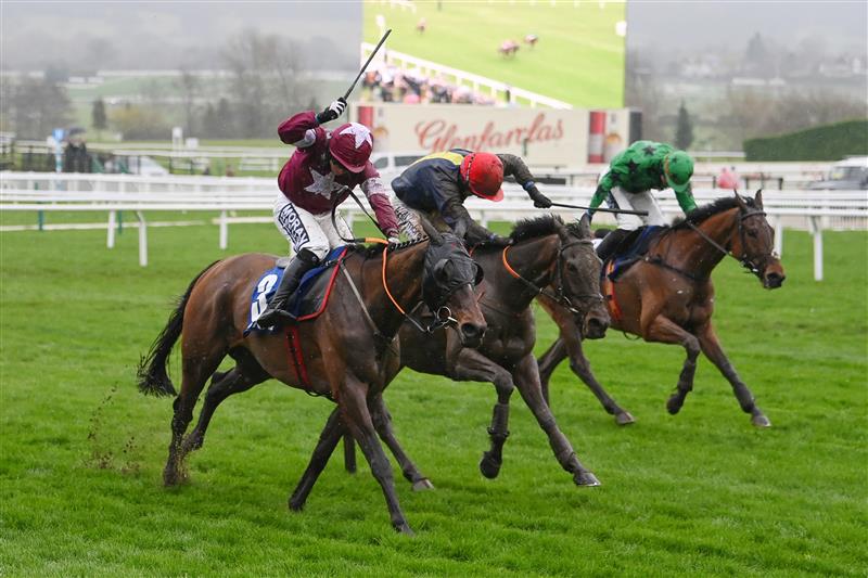 CHELTENHAM, ENGLAND - MARCH 16: Shane Fitzgerald (white star kit) on Commander Of Fleet approach the finish line before Darragh O'Keeffe (red cap) on Fastorslow to win the Coral Cup Handicap Hurdle race during day two of Cheltenham Festival 2022 at Cheltenham Racecourse on March 16, 2022 in Cheltenham, England. (Photo by Mike Hewitt/Getty Images)