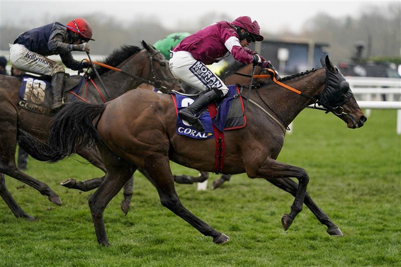 CHELTENHAM, ENGLAND - MARCH 16: Shane Fitzgerald riding Commander Of Fleet (maroon) clear the last to win The Coral Cup Handicap Hurdle on day two of The Festival at Cheltenham Racecourse on March 16, 2022 in Cheltenham, England. (Photo by Alan Crowhurst/Getty Images)
