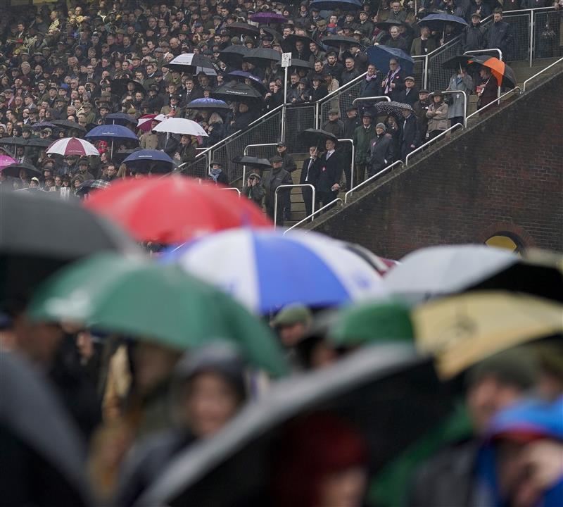 CHELTENHAM, ENGLAND - MARCH 16: A very wet day as racegoers watch the first race on day two of The Festival at Cheltenham Racecourse on March 16, 2022 in Cheltenham, England. (Photo by Alan Crowhurst/Getty Images)