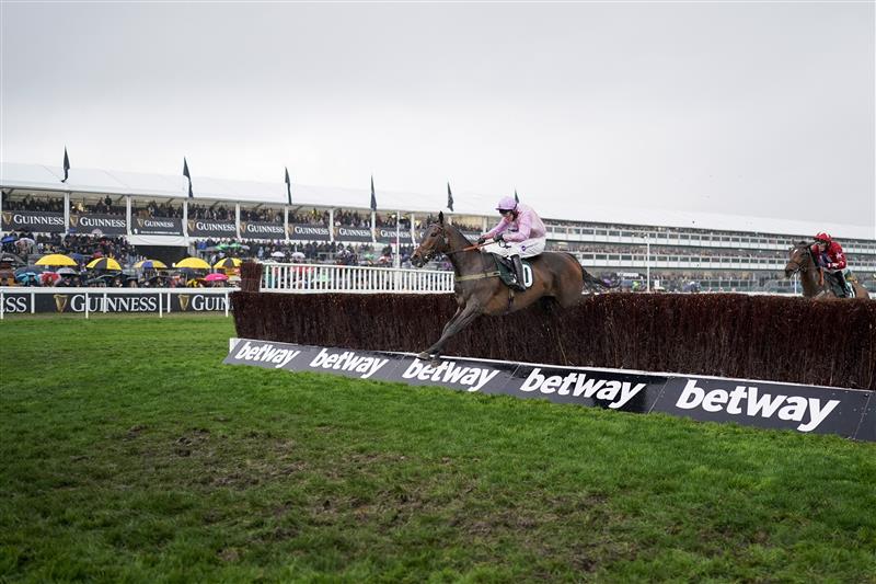 CHELTENHAM, ENGLAND - MARCH 16: Kielan Woods riding Global Citizen clear the last to win The Johnny Henderson Grand Annual Challenge Cup Handicap Chase on day two of The Festival at Cheltenham Racecourse on March 16, 2022 in Cheltenham, England. (Photo by Alan Crowhurst/Getty Images)