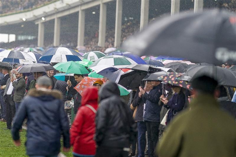 CHELTENHAM, ENGLAND - MARCH 16: A very wet day as racegoers watch the first race on day two of The Festival at Cheltenham Racecourse on March 16, 2022 in Cheltenham, England. (Photo by Alan Crowhurst/Getty Images)