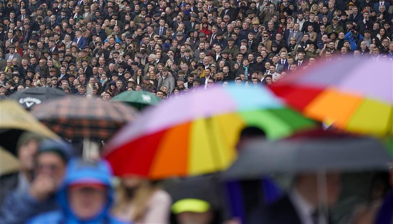 CHELTENHAM, ENGLAND - MARCH 16: A very wet day as racegoers watch the first race on day two of The Festival at Cheltenham Racecourse on March 16, 2022 in Cheltenham, England. (Photo by Alan Crowhurst/Getty Images)