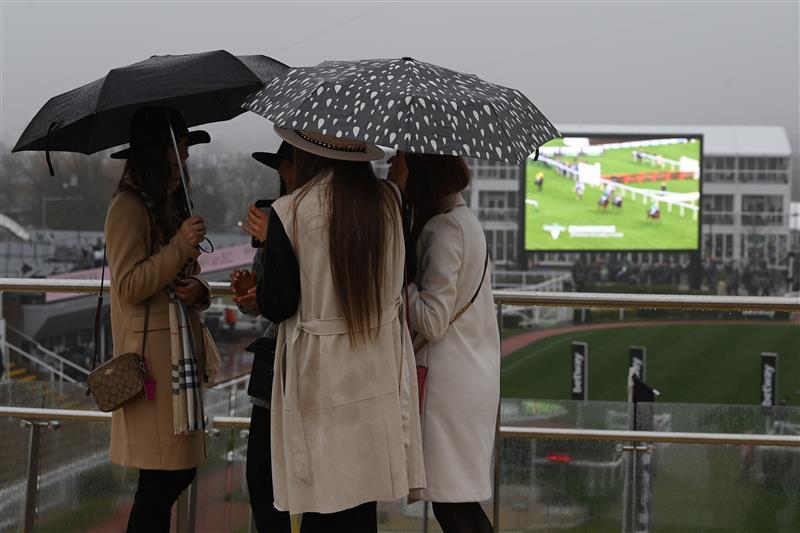 CHELTENHAM, ENGLAND - MARCH 16: Spectators brave the heavy rain on day two of the Cheltenham Festival 2022 at Cheltenham Racecourse on March 16, 2022 in Cheltenham, England. (Photo by Mike Hewitt/Getty Images)