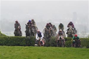 CHELTENHAM, ENGLAND - MARCH 16: Jack Kennedy riding Delta Work (L, blue cap) jump the 'Cheese Wedges' on their way to winning The Glenfarclas Chase on day two of The Festival at Cheltenham Racecourse on March 16, 2022 in Cheltenham, England. (Photo by Alan Crowhurst/Getty Images)