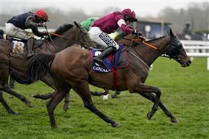 CHELTENHAM, ENGLAND - MARCH 16: Shane Fitzgerald riding Commander Of Fleet (maroon) clear the last to win The Coral Cup Handicap Hurdle on day two of The Festival at Cheltenham Racecourse on March 16, 2022 in Cheltenham, England. (Photo by Alan Crowhurst/Getty Images)