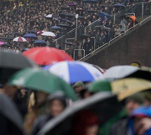 CHELTENHAM, ENGLAND - MARCH 16: A very wet day as racegoers watch the first race on day two of The Festival at Cheltenham Racecourse on March 16, 2022 in Cheltenham, England. (Photo by Alan Crowhurst/Getty Images)