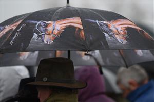 CHELTENHAM, ENGLAND - MARCH 16: Spectators brave the heavy rain on day two of the Cheltenham Festival 2022 at Cheltenham Racecourse on March 16, 2022 in Cheltenham, England. (Photo by Mike Hewitt/Getty Images)