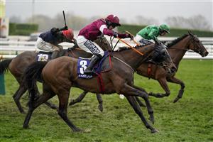 CHELTENHAM, ENGLAND - MARCH 16: Shane Fitzgerald riding Commander Of Fleet (maroon) clear the last to win The Coral Cup Handicap Hurdle on day two of The Festival at Cheltenham Racecourse on March 16, 2022 in Cheltenham, England. (Photo by Alan Crowhurst/Getty Images)
