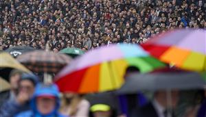CHELTENHAM, ENGLAND - MARCH 16: A very wet day as racegoers watch the first race on day two of The Festival at Cheltenham Racecourse on March 16, 2022 in Cheltenham, England. (Photo by Alan Crowhurst/Getty Images)