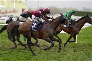 CHELTENHAM, ENGLAND - MARCH 16: Shane Fitzgerald riding Commander Of Fleet (maroon) clear the last to win The Coral Cup Handicap Hurdle on day two of The Festival at Cheltenham Racecourse on March 16, 2022 in Cheltenham, England. (Photo by Alan Crowhurst/Getty Images)