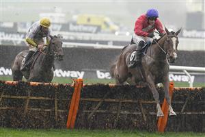 CHELTENHAM, ENGLAND - MARCH 16: Paul Townend riding Sir Gerhard (red) clear the last to win The Ballymore Novices' Hurdle on day two of The Festival at Cheltenham Racecourse on March 16, 2022 in Cheltenham, England. (Photo by Alan Crowhurst/Getty Images)