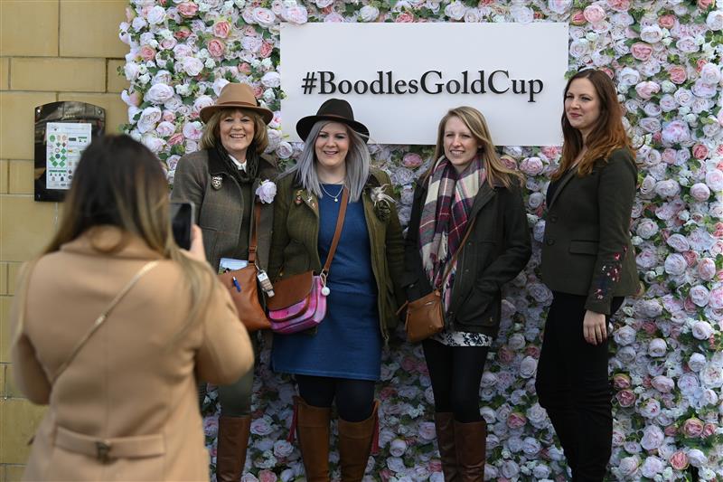 CHELTENHAM, ENGLAND - MARCH 17: Fans pose for a photo opportunity on day three of the Cheltenham Festival 2022 at Cheltenham Racecourse on March 17, 2022 in Cheltenham, England. (Photo by Mike Hewitt/Getty Images)