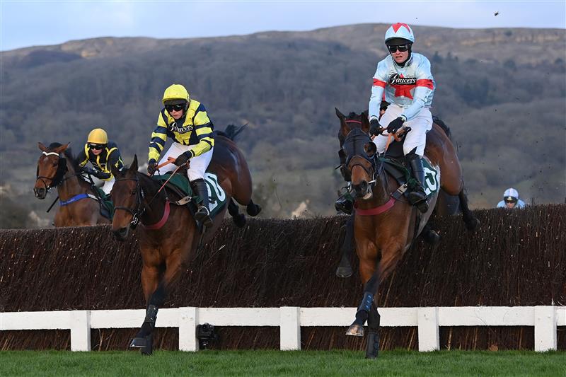 CHELTENHAM, ENGLAND - MARCH 17: Lucy Turner and Chambard (L) jump the 3rd last on their way to victory in the Fulke Walwyn Kim Muir Challenge Cup Amateur Jockeys' Handicap Chase on day three of the Cheltenham Festival 2022 at Cheltenham Racecourse on March 17, 2022 in Cheltenham, England. (Photo by Mike Hewitt/Getty Images)