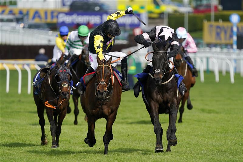 CHELTENHAM, ENGLAND - MARCH 17: Tom O'Brien (black and pink kit) on Third Wind approach the finish line before Paddy Brennan (black and yellow kit) on Alaphilippe to win The Pertemps Network Final Handicap Hurdle race during day three of The Cheltenham Festival 2022 at Cheltenham Racecourse on March 17, 2022 in Cheltenham, England. (Photo by Alan Crowhurst/Getty Images)