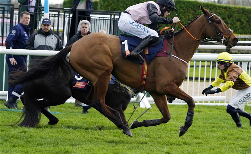 CHELTENHAM, ENGLAND - MARCH 17: Rachael Blackmore (black and pink kit) on Bob Olinger pass Paul Townend (yellow and brown kit) and Galopin Des Champs who parted ways after the last in The Turners Novices’ Chase race during day three of The Cheltenham Festival 2022 at Cheltenham Racecourse on March 17, 2022 in Cheltenham, England. (Photo by Alan Crowhurst/Getty Images)
