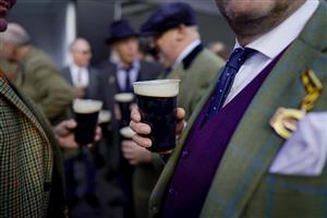 CHELTENHAM, ENGLAND - MARCH 17: Racegoers in the Guinness Village on St Patrick's Day on day three of The Festival at Cheltenham Racecourse on March 17, 2022 in Cheltenham, England. (Photo by Alan Crowhurst/Getty Images)