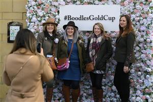 CHELTENHAM, ENGLAND - MARCH 17: Fans pose for a photo opportunity on day three of the Cheltenham Festival 2022 at Cheltenham Racecourse on March 17, 2022 in Cheltenham, England. (Photo by Mike Hewitt/Getty Images)