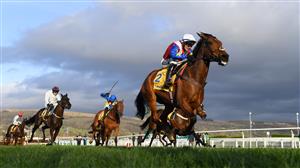CHELTENHAM, ENGLAND - MARCH 17: Jonathan Burke (white cap) on Love Envoi approach the finish line to win The Dawn Run Mares’ Novices’ Hurdle race during day three of The Cheltenham Festival 2022 at Cheltenham Racecourse on March 17, 2022 in Cheltenham, England. (Photo by Mike Hewitt/Getty Images)