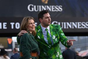 CHELTENHAM, ENGLAND - MARCH 17: Irish themed spectators arrive on St Patrick's Day on day three of the Cheltenham Festival 2022 at Cheltenham Racecourse on March 17, 2022 in Cheltenham, England. (Photo by Mike Hewitt/Getty Images)