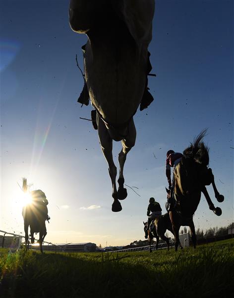CHELTENHAM, ENGLAND - MARCH 18: Runners and riders jump the third last in the Mrs Paddy Power Mares' Chase on day four of the Cheltenham Festival 2022 at Cheltenham Racecourse on March 18, 2022 in Cheltenham, England. (Photo by Mike Hewitt/Getty Images)