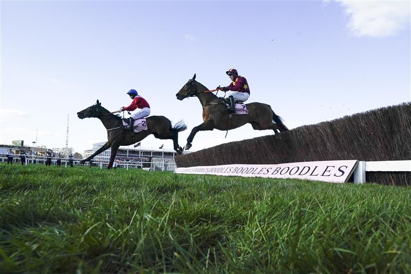 CHELTENHAM, ENGLAND - MARCH 18: Rachael Blackmore riding A Plus Tard (L, red) clear the last to win The Boodles Cheltenham Gold Cup Chase on day four of The Festival at Cheltenham Racecourse on March 18, 2022 in Cheltenham, England. (Photo by Alan Crowhurst/Getty Images)