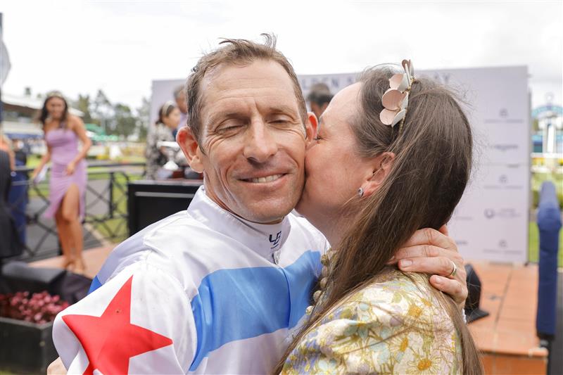 SYDNEY, AUSTRALIA - MARCH 19: Hugh Bowman hugs wife Christine Bowman after winning race 7 The Agency George Ryder Stakes on Forbidden Love during Sydney Racing Longines Golden Slipper Day, at Rosehill Gardens on March 19, 2022 in Sydney, Australia. (Photo by Jenny Evans/Getty Images)