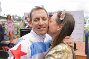 SYDNEY, AUSTRALIA - MARCH 19: Hugh Bowman hugs wife Christine Bowman after winning race 7 The Agency George Ryder Stakes on Forbidden Love during Sydney Racing Longines Golden Slipper Day, at Rosehill Gardens on March 19, 2022 in Sydney, Australia. (Photo by Jenny Evans/Getty Images)
