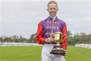 SYDNEY, AUSTRALIA - MARCH 19: Kerrin McEvoy holds the Queen's Cup during Sydney Racing Longines Golden Slipper Day, at Rosehill Gardens on March 19, 2022 in Sydney, Australia. (Getty)